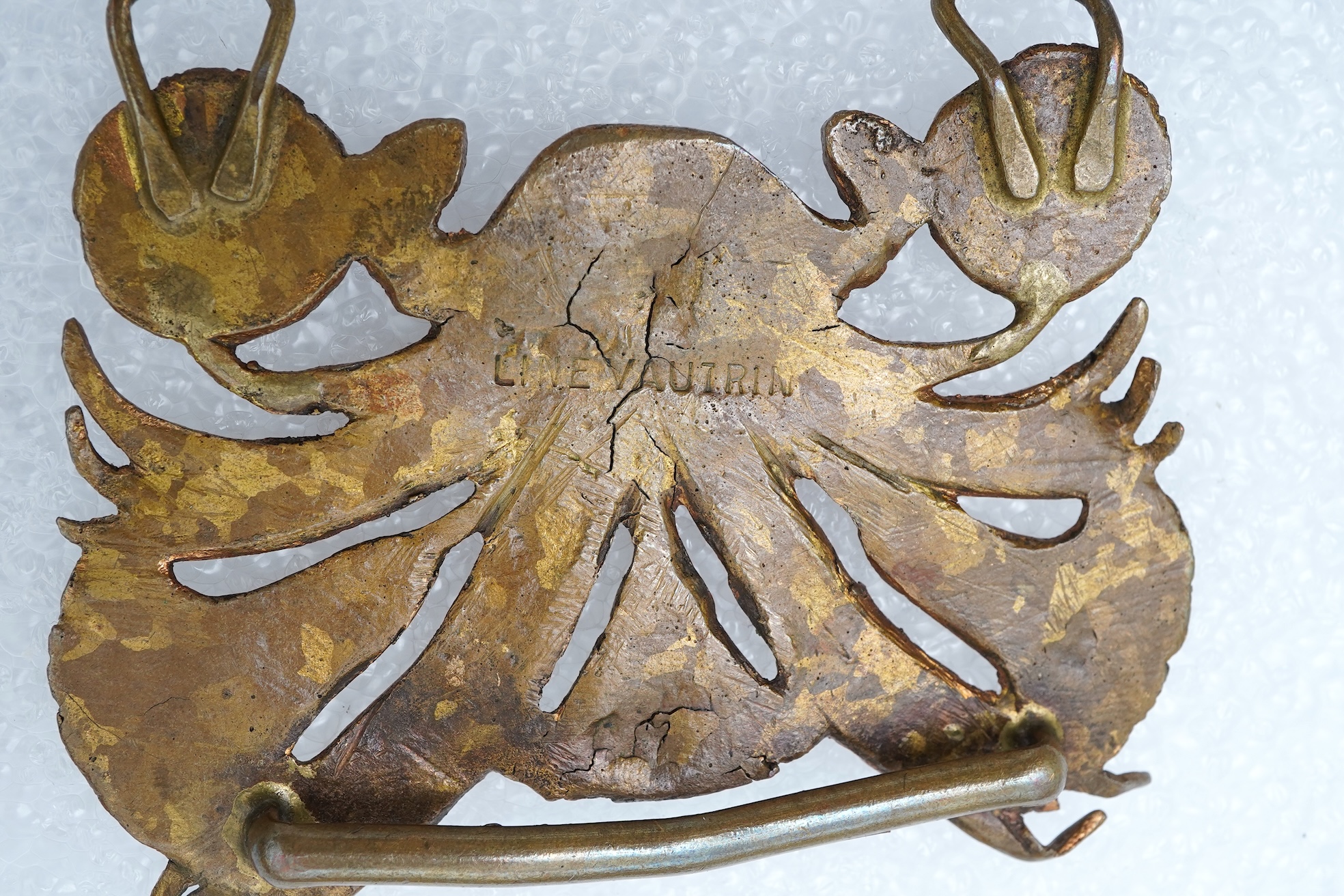 Line Vautrin, a gilt bronze belt buckle